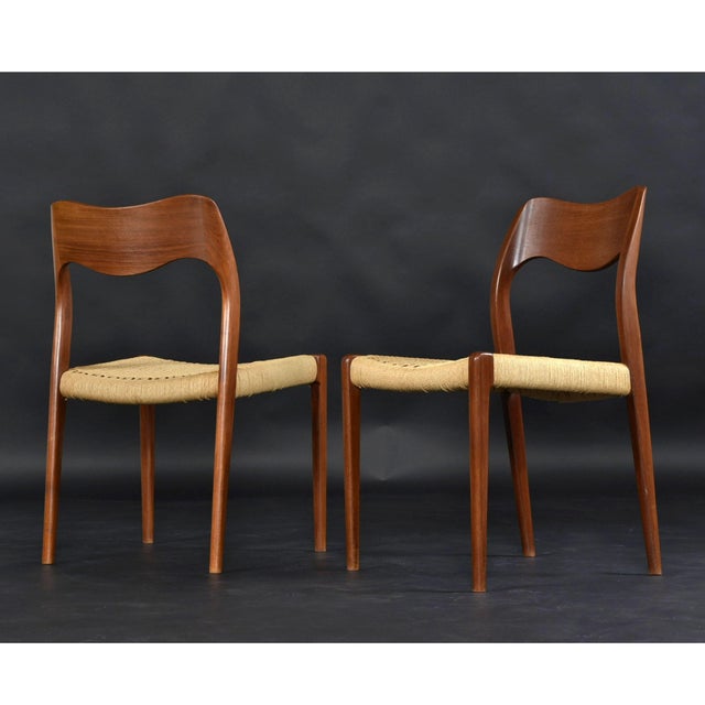 A sculptural and highly sought-after set of eight Model 71 dining chairs designed by Niels Otto Møller for J.L. Møllers...