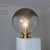 Description Table lamp produced by La Murrina. The large spherical diffuser is made of transparent glass and has an...