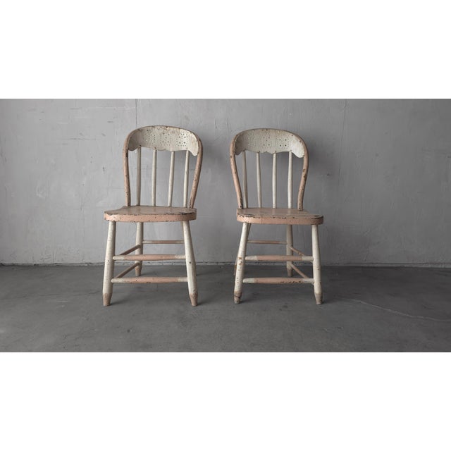 These are a really nice, honest pair of primitive American spindle-back chairs with a Windsor-influenced form. Each...
