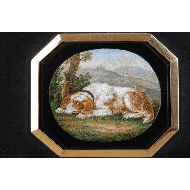 A rectangular marble paperweight with octogonal inlaid micromosaic plate. The plaque depicting a spaniel in a landscape,...