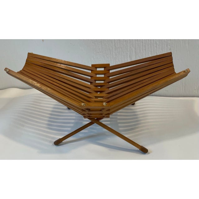 Love this modernist design stick bowl or stand. May be teak wood. Folds flat for storage
