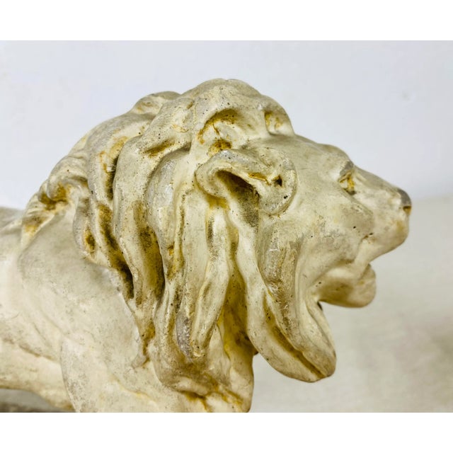 This is a mid century vintage plaster lion sculpture. This lion sculpture has a textured rustic patina to the surface....
