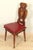 Set of six Italian Renaissance-style chairs in solid walnut, finely carved and featuring openwork backs with floral and...