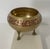 This charming vintage brass tripod bowl brings a touch of exotic sophistication to any space. Handcrafted in India and...