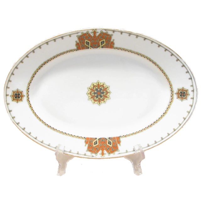 Antique handpainted ironstone platter and four luncheon plates in a colorful coat of arms motif. Mark en verso of C.T....