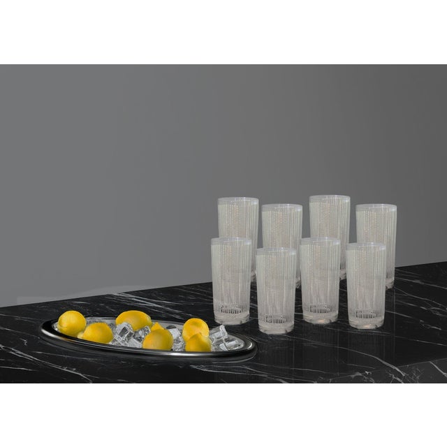 An exquisite midcentury set of eight Georges Briard “Icicle White” tumblers featuring a frosted vertical motif that...