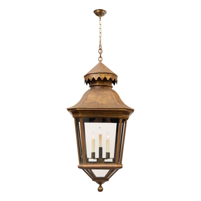 Large French lantern made of brass with 8 panes of glass. The lantern holds four candelabra lights. We were drawn to the...
