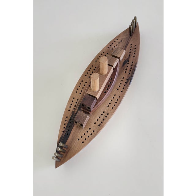 A novelty cribbage board made in the 1970s of Oregon Myrtlewood. Includes 8 solid brass spilikins (pegs) which double as...