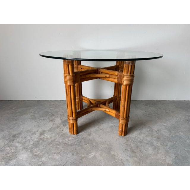 Elevate your space with this charming Vintage Coastal Rattan Dining Table, featuring a sturdy handcrafted rattan base and...