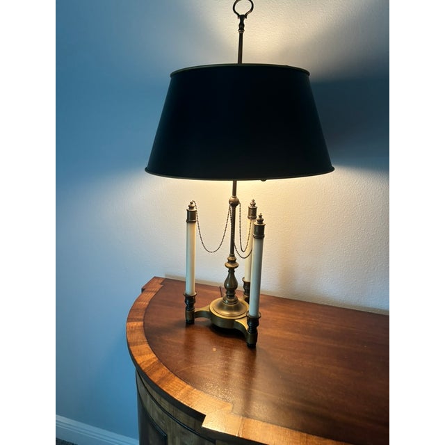 This lamp has been in my family for 65+ years. It has a brass base with three candlestick arms and black shade. This...