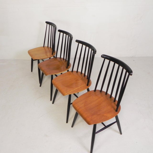Four elegant Fanett chairs. Clean lines, comfortable seating, and subtle signs of wear make them an authentic vintage...