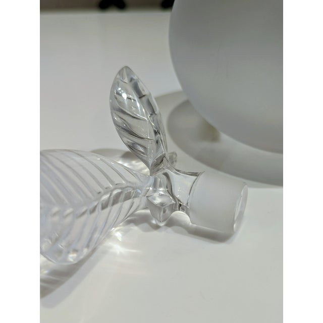 Vintage Lalique crystal perfume bottle in the iconic Pomme apple form. Satin-finished frosted body with clear sculptural...