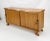 Rustic live edge sideboard is crafted from solid wood, showcasing natural grain patterns and a warm, earthy tone....