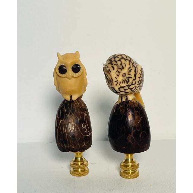 Gorgeous pair of artisan carved owl figurines mountedd on brass bases as lamp finials.