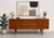 Vintage Danish Mid Century Modern Teak Credenza, crafted in the 1960s. This minimalist yet highly functional design works...