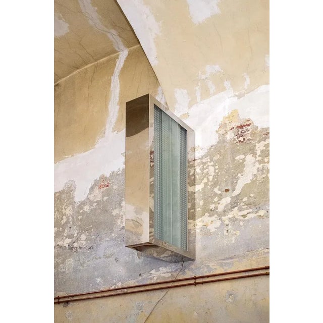 Sculpture lamp with aluminum frame, glass interior and mirror. Chronotope model Designer Nanda Vigo 2000s This piece has...