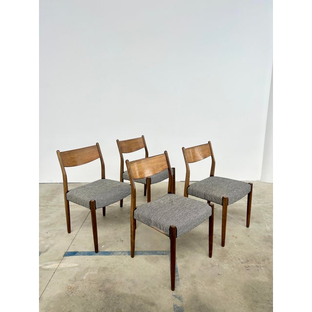 A set of four chairs with beautifully aged teak frames. We reupholstered the seats in a stunning black and white fabric...