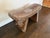 Charming hand-painted wooden stool from India featuring a gently curved, saddle-style seat and simple tapered legs....