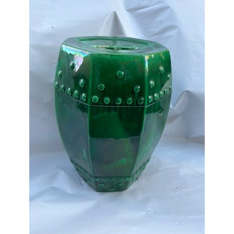 A single vintage octagonal ceramic garden bench or barrel featuring a rich green glazed finish, lugs, and pierced decoration.