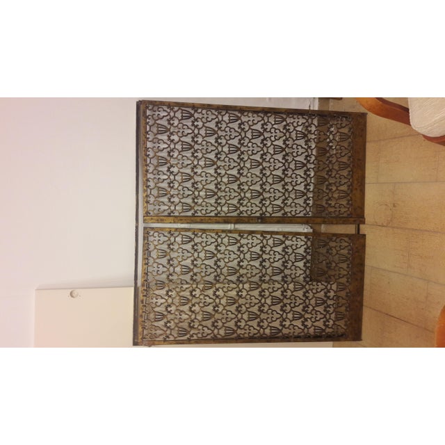 This pair of bronze doors, attributed to Raymond Subes, has two panels with an interlinking vase design, mounted within a...