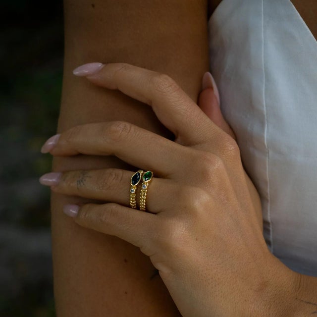 Sophisticated and graceful, the Sapphire Teardrop Gemstone Adjustable Gold Ring shines with its deep blue marquise-cut...