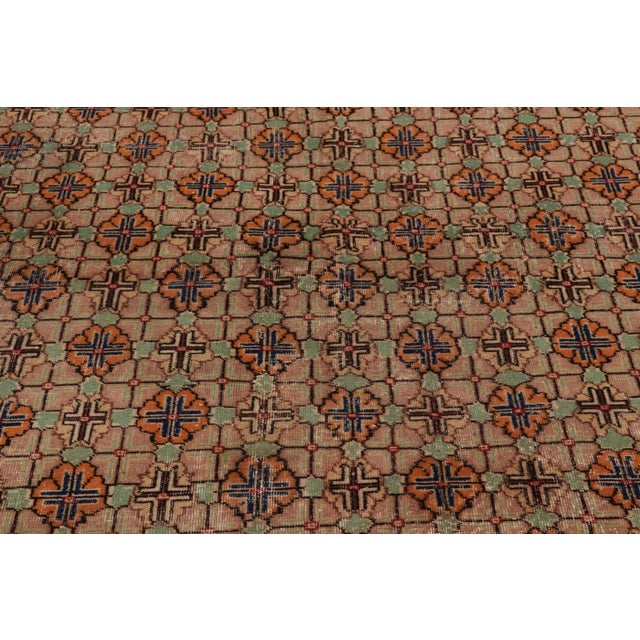 This vintage rug is a 7x10 Turkish distressed piece, made with hand-knotted wool circa mid-20th century. It is an exciting...
