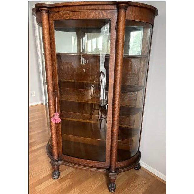 Antique tiger oak China/curio cabinet, dating from the early 1900s, featuring curved (bowed) glass panels (2 side panels,...