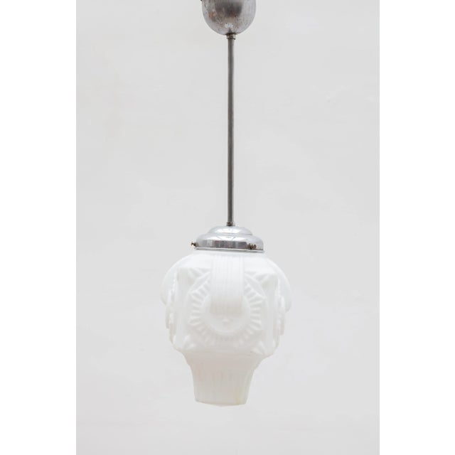 Beautiful pendant with a white opal embossed Art Deco motif glass shade authentic made in the 1920s. The shade is a...
