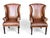 This vintage pair of cognac leather wingback chairs combines classic comfort with Louis XVI–inspired detailing. Tall...
