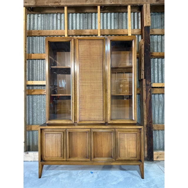This beautiful walnut hutch with cane accents is the perfect size to display your favorite dinnerware set, and then some....