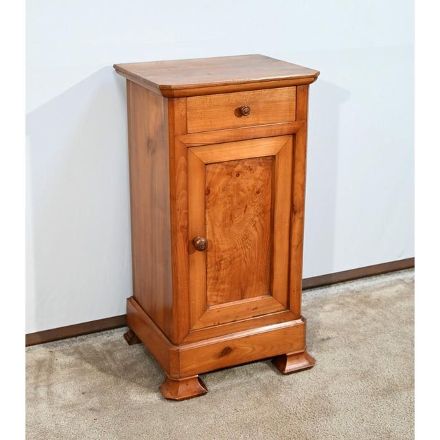 This little bedside table opens by a belt drawer with a turned wooden button. Below this small piece of furniture also has...