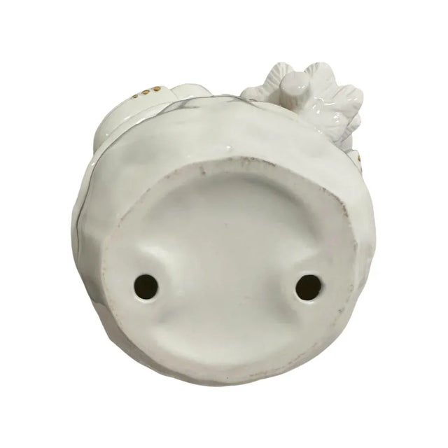 Add a touch of vintage charm to your holiday decor with this gorgeous white ceramic snowman, elegantly trimmed in...