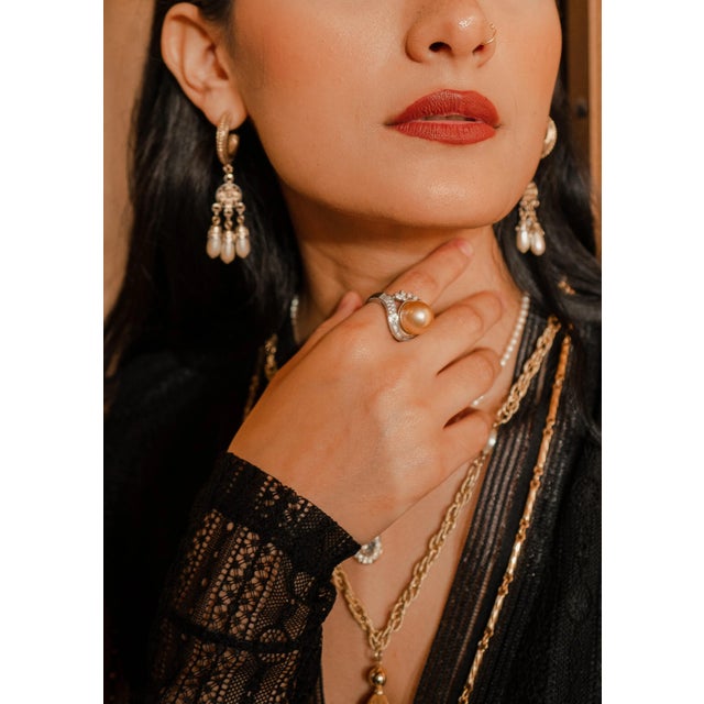 This elegant cocktail ring features an 18K white gold Art Deco-style setting with a single 13 mm AAA quality South Sea...