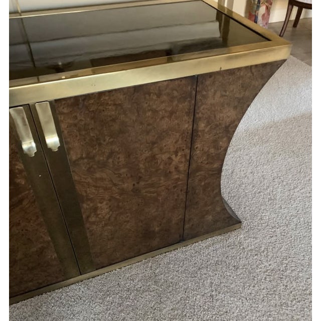 This striking piece is a Mastercraft Amboyna Burl and Brass Sideboard, a prominent mid-century modern design from the...