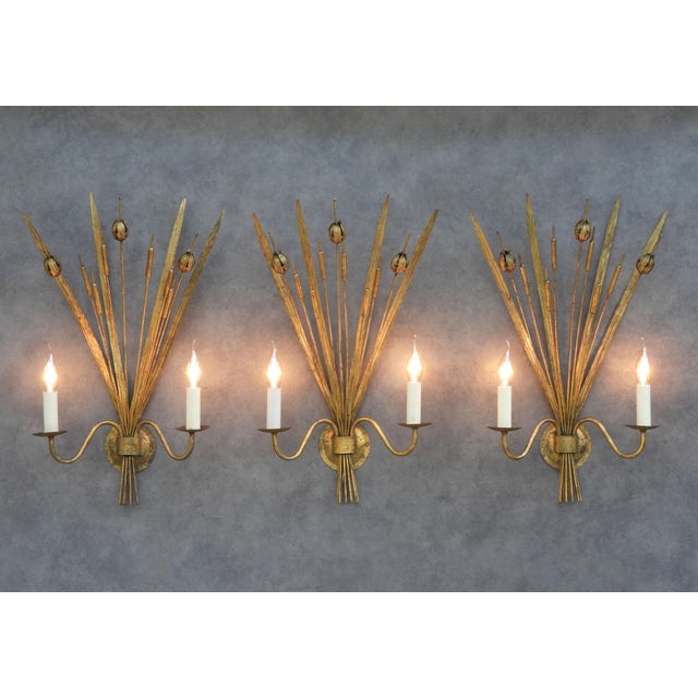 Rare and highly decorative Spanish gilt tole wall sconces dating from the mid-20th century. Each sconce is beautifully...
