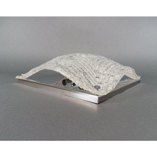 A large flush lamp of handmade textured glass with a ‘corrugated’ front in a concentric design ,and an overshot back...