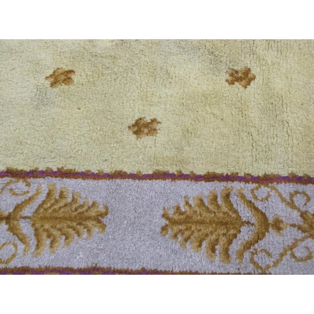 Beautiful French Savonnerie rug with a Louis XVI style design, early 20th century with nice yellow field and purple...
