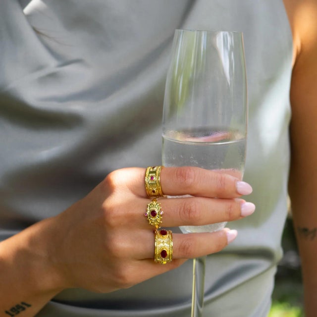 Mystic Queen Ruby Cuff Gold Ring Ignite your inner fire with the Mystic Queen Ruby Cuff Gold Ring, a striking treasure...