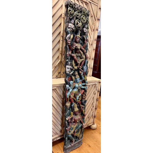 Stunning wall sculpture has been hand carved from one tall piece of wood and features three Hindu gods. The central blue...