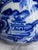 Vintage Asian Chinese flow blue and white porcelain vase. It features striking blue designs of a village scene with...