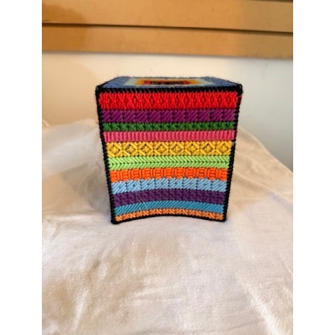 Multi-colored handmade tissue box cover. Plastic grid mesh stitched with colorful yarn. It can stand up just fine around...