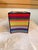 Multi-colored handmade tissue box cover. Plastic grid mesh stitched with colorful yarn. It can stand up just fine around...