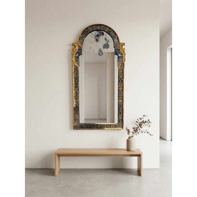 Queen Anne style pier mirror featuring verre églomisé (reverse-painted and gilded glass panels) with intricate scrollwork,...