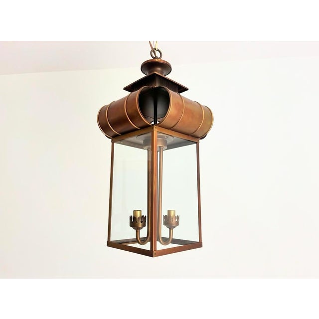 Fabulous 1960s traditional lantern pendant light featuring a warm coppery bronze elongated square metal frame and glass...