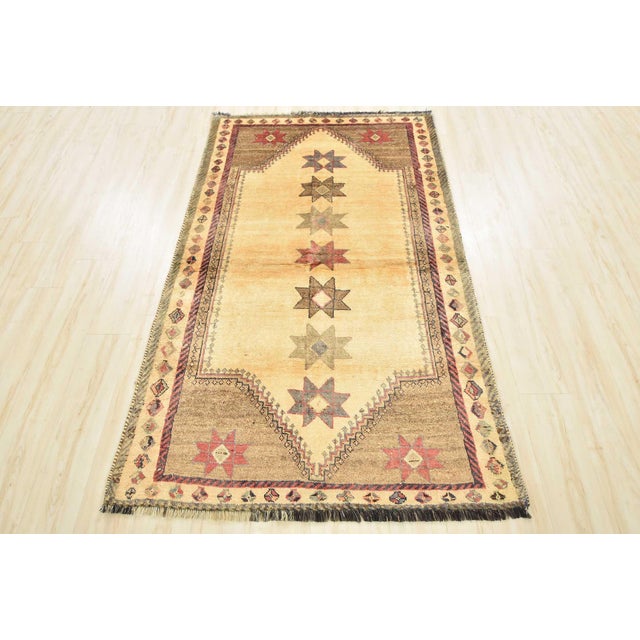 An authentic vintage tribal Qashqai rug hand-knotted with fine wool and natural dyes. This nomadic oriental rug features a...