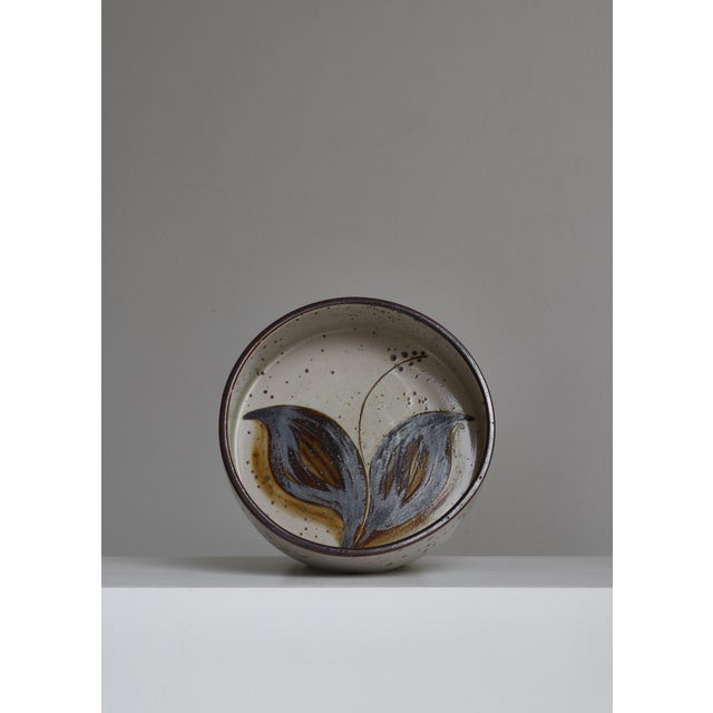 Large beautiful stoneware bowl handmade at Søholm Stoneware, Denmark in the 1970s. The bowl is hand decorated with a...