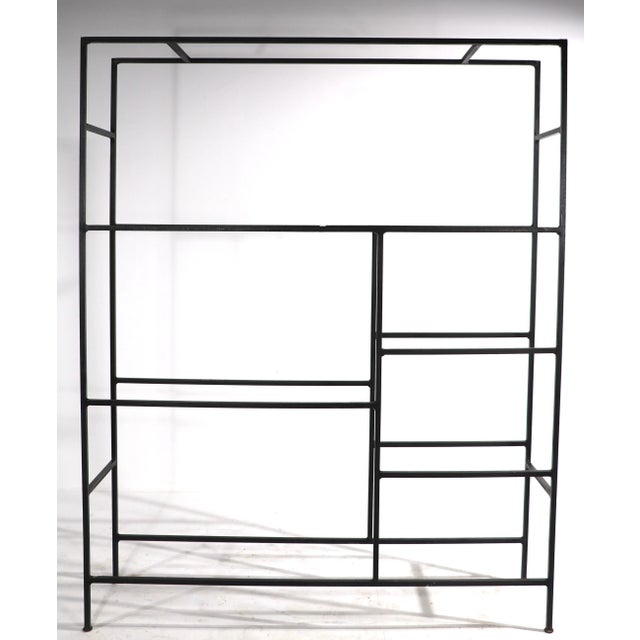 Unusual and rare mid century shelf unit having an iron frame, with marble, and metal mesh shelves. The marble shelves fit...