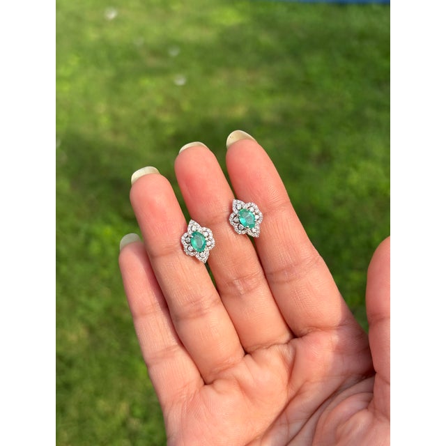 These stud earrings feature 0.78 carat of natural emeralds set in 14K white gold. Each rich green emerald measures...