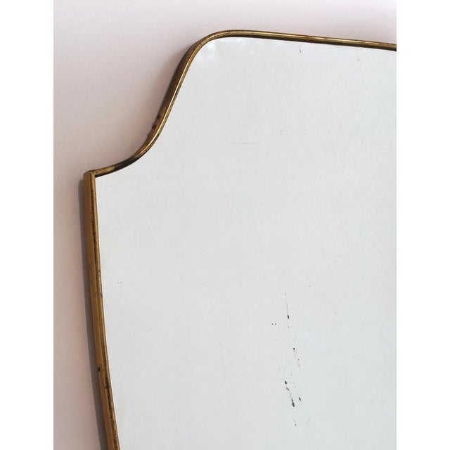 Mid-Century Italian wall mirror with brass frame (circa 1960s). This mirror is simply elegant and characterful in a...