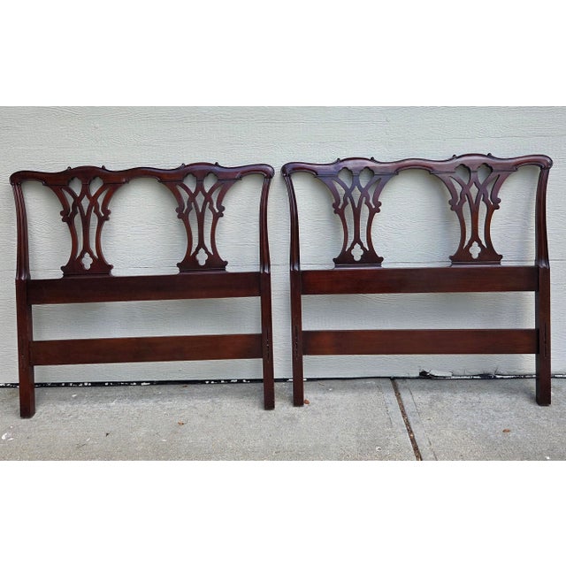 A pair of mahogany twin headboards from the Drexel 18th Century Classics Collection. Includes the Footboards. There are no...